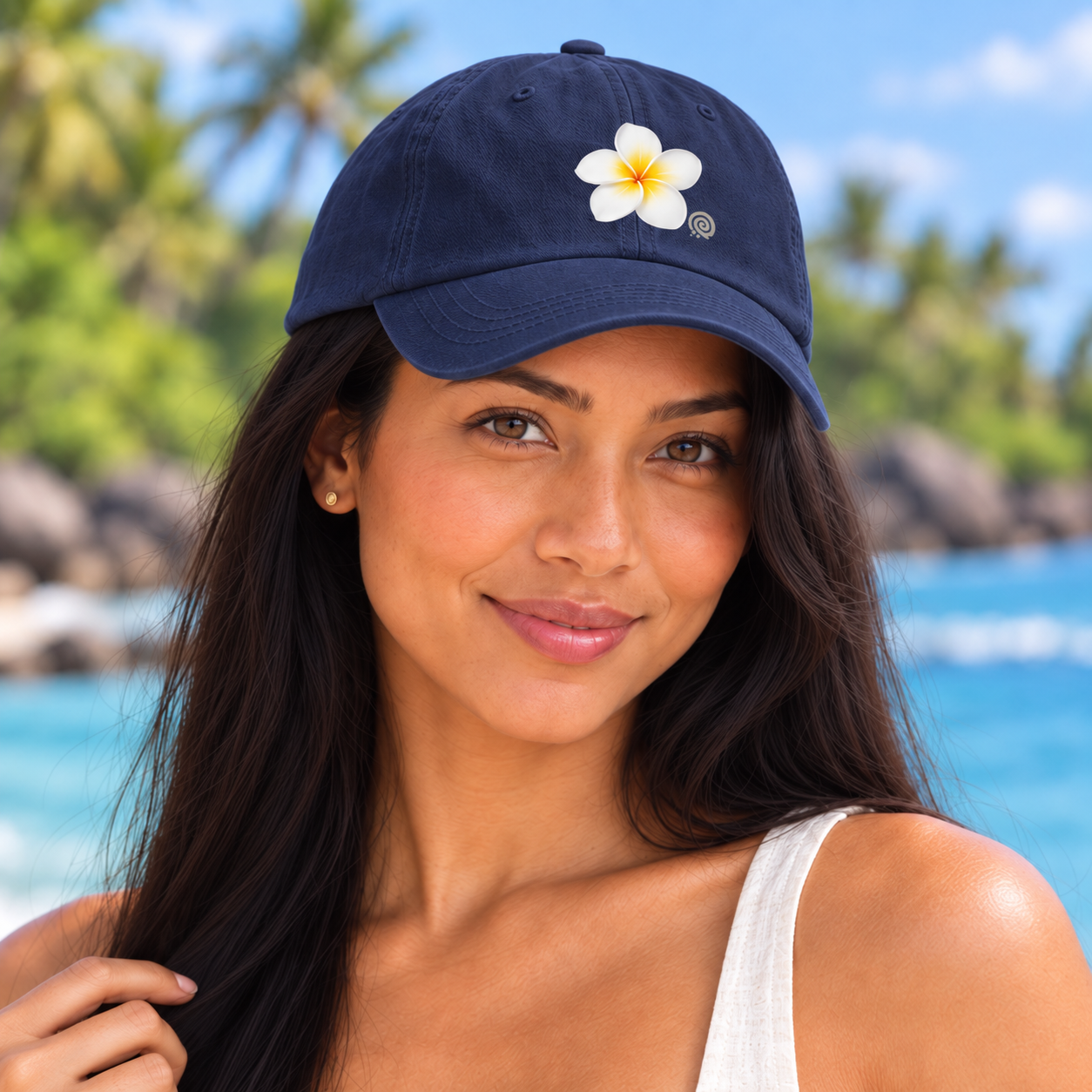 Close-up of Digital Piko female model wearing the navy white plumeria cap, showing the white flower, yellow center and small gray spiral logo