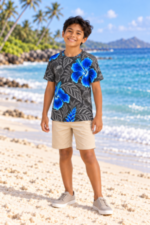 Digital Piko family boy model wearing the Graphite Bright Blue kids crewneck T-shirt with cream shorts on a white sand beach