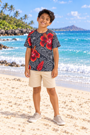 Digital Piko family boy model wearing the Graphite Coral Ohana Kids Crewneck T-Shirt with cream shorts and sneakers on a white sand beach, full length